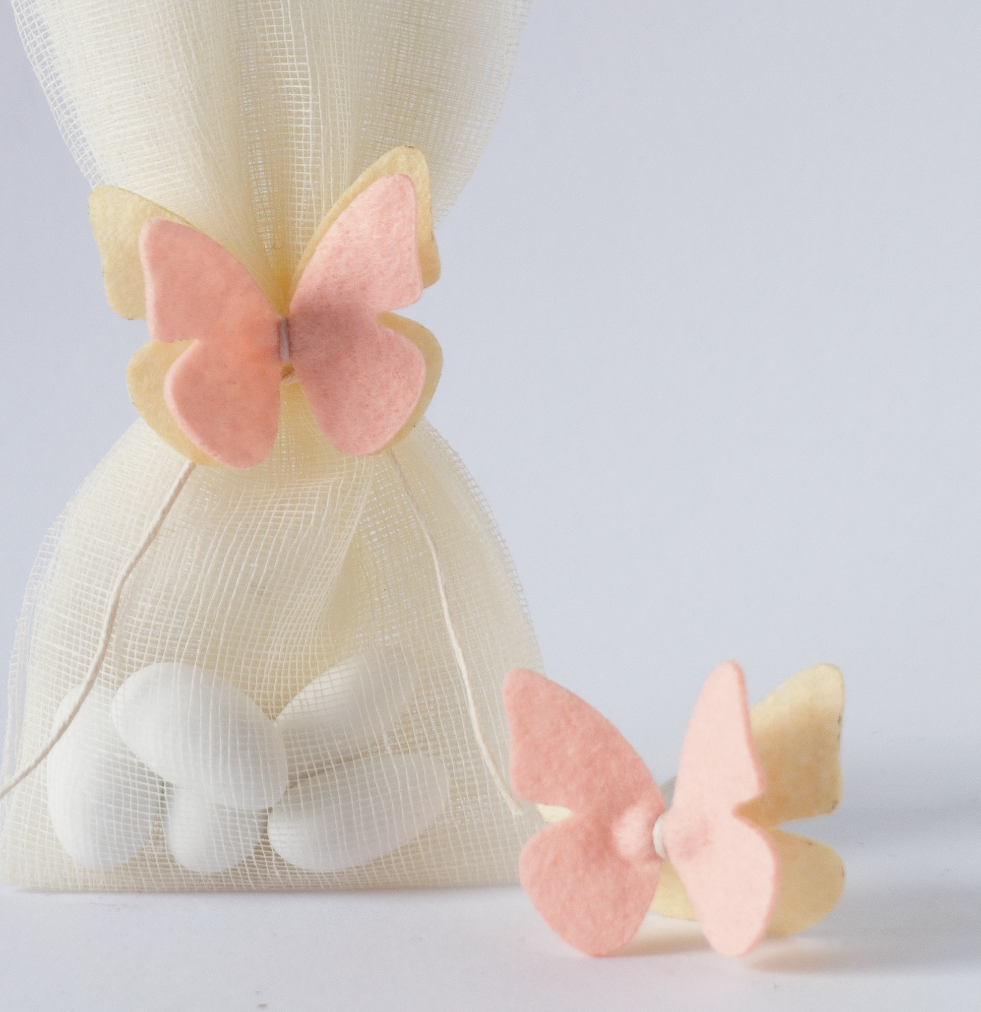 Elegant μπομπονιέρα βάπτισης με ροζ butterfly hair accessory και soft αποχρώσεις